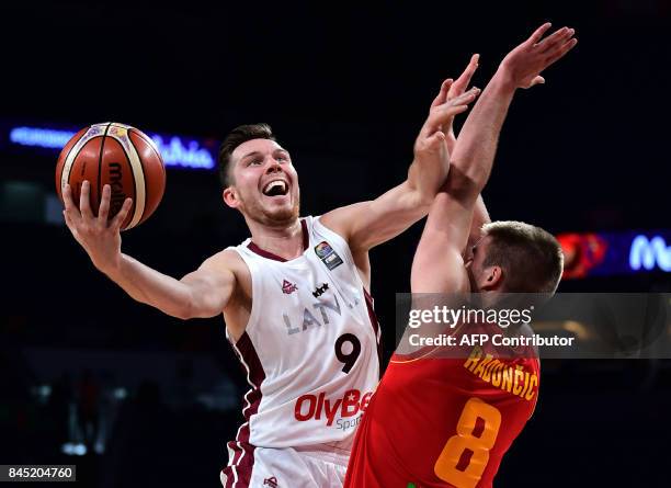 Latvia's guard Dairis Bertans vies with Montenegro's forward Dino Rodoncic during FIBA Eurobasket 2017 men's round of 16 basketball match between...