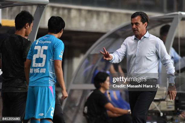 Head coach Massimo Ficcadenti of Sagan Tosu gives instruction to An Yong Woo during the J.League J1 match between Vegalta Sendai and Sagan Tosu at...