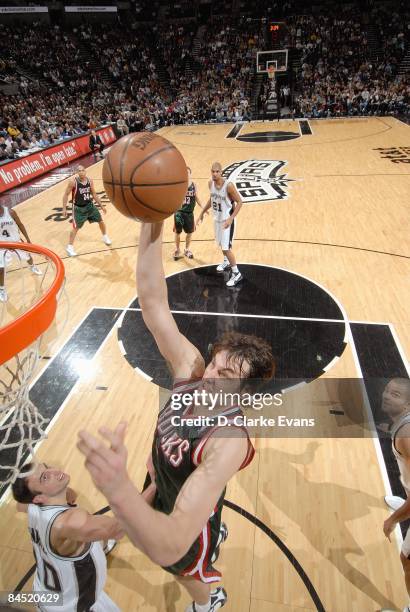 Andrew Bogut of the Milwaukee Bucks puts a shot up against Manu Ginobili of the San Antonio Spurs during a game at AT&T Center on December 30, 2008...