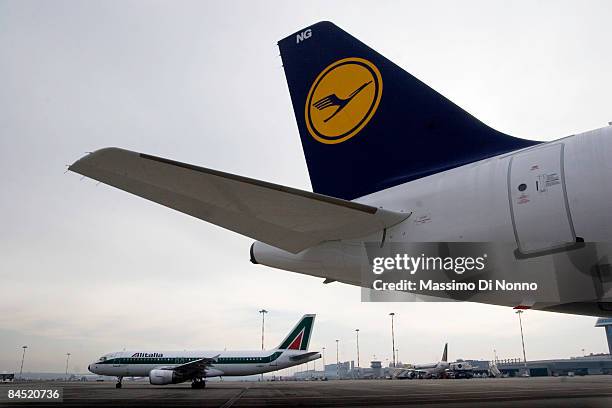 An Alitalia aircraft passes a Luftahansa plane on the runway during a press conference introducing two new planes at Milan Malpensa International...