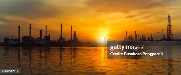 oil and gas industry, petrochemical plant area in morning with reflection in river - saudi arabia industry stock pictures, royalty-free photos & images