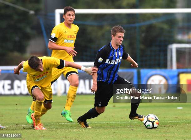 Xian Emmers of FC Internazionale U19 competes for the ball with Filippo Paoluzzi of Udinese Calcio during the Serie A Primavera match between FC...