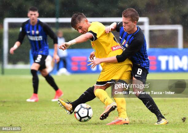 Xian Emmers of FC Internazionale U19 competes for the ball with Filippo Paoluzzi of Udinese Calcio during the Serie A Primavera match between FC...