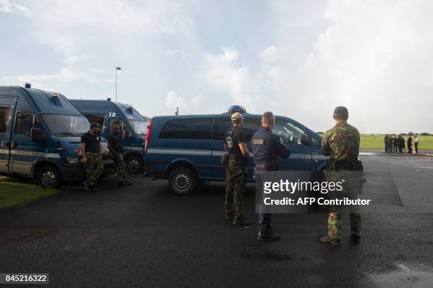 National Gendarmerie Intervention Group units of the French National Police wait on September 10, 2017 to leave Pointe-a-Pitre International Airport...