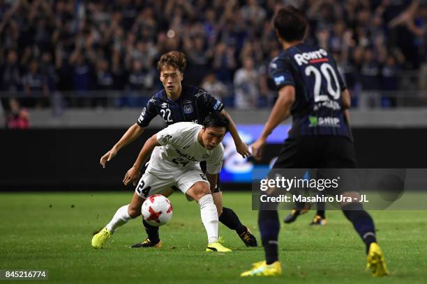 Masatoshi Mihara of Vissel Kobe controls the ball under pressure of Oh Jae Suk of Gamba Osaka during the J.League J1 match between Gamba Osaka and...