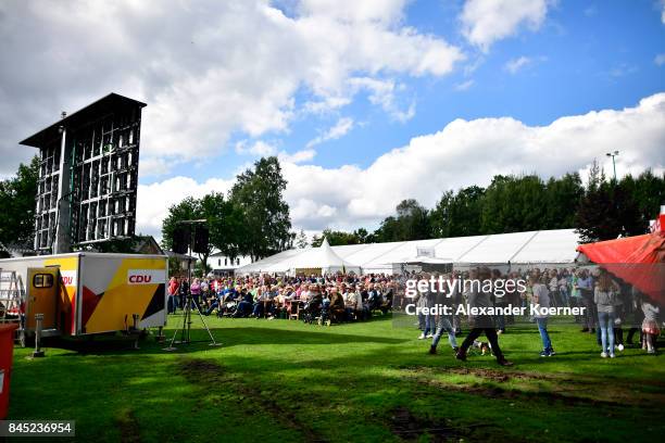 Supporters of German Chancellor and Christian Democrat Angela Merkel listen to her speech at a fest tent during an election campaign stop on...