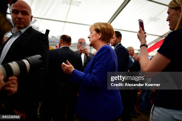 German Chancellor and Christian Democrat Angela Merkel arrives to speak to supporters at a fest tent during an election campaign stop on September...