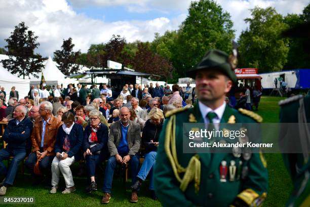 Supporters of German Chancellor and Christian Democrat Angela Merkel wait for her arrival at a fest tent during an election campaign stop on...