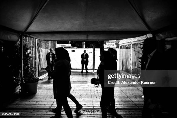 Supporters of German Chancellor and Christian Democrat Angela Merkel stand in line prior a speech to supporters at a fest tent during an election...