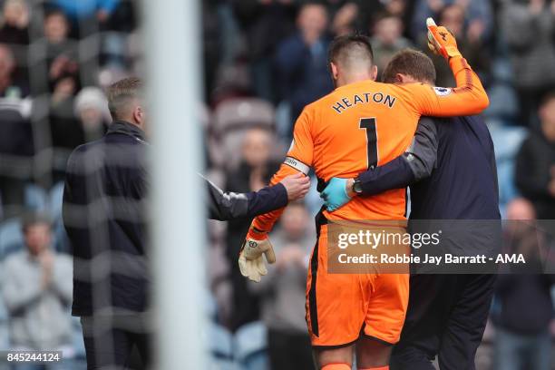 Tom Heaton of Burnley goes off injured during the Premier League match between Burnley and Crystal Palace at Turf Moor on September 10, 2017 in...