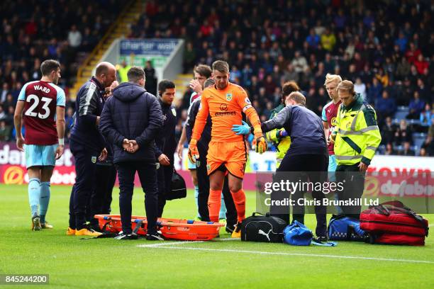 Tom Heaton of Burnley leaves the field through injury during the Premier League match between Burnley and Crystal Palace at Turf Moor on September...