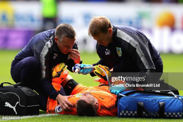 Tom Heaton of Burnley receives treatment during the Premier League match between Burnley and Crystal Palace at Turf Moor on September 10, 2017 in...