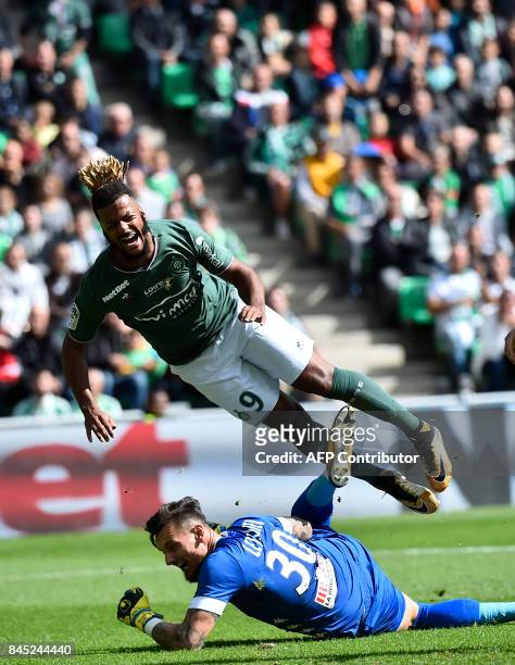 Saint-Etienne's French forward Lois Diony vies with Anger's French goalkeeper Alexandre Letellier during the French L1 football match between...