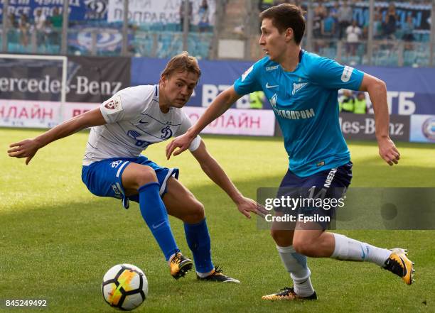 Kirill Panchenko of FC Dinamo Moscow vies for the ball with Daler Kuzyaev of FC Zenit Saint-Petersbur during during the Russian Premier League match...