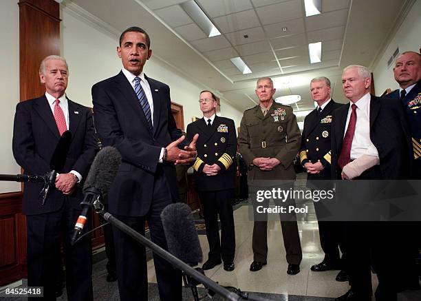 Vice President Joe Biden and Secretary of Defense Robert Gates stand with the Joint Chiefs of Staff while President Barack Obama speaks to reporters...