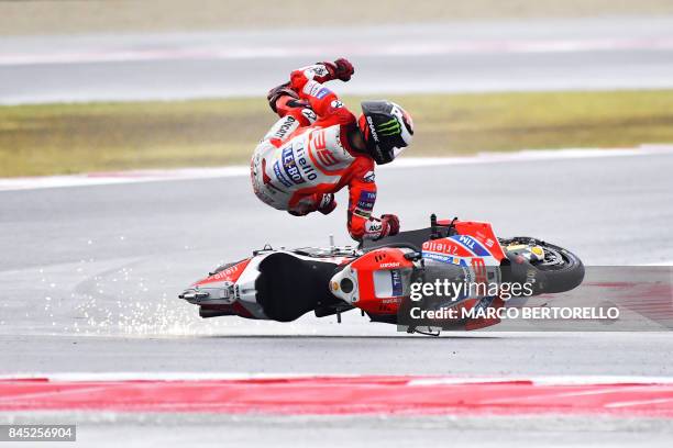 Ducati Team's Spanish rider Jorge Lorenzo falls from his bike during the San Marino Moto GP Grand Prix at the Marco Simoncelli Circuit in Misano, on...