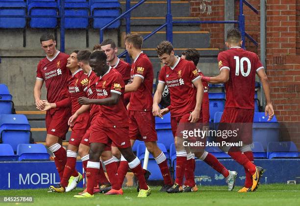 Yan Dhanda of Liverpool celabrates scoring the winning goal with his team mates during the game at Prenton Park on September 10, 2017 in Birkenhead,...