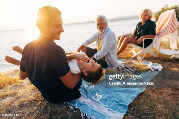 seaside picnic with family - picnic stock pictures, royalty-free photos & images