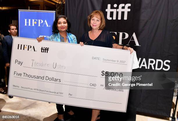 President Meher Tatna and TIFF Executive Director and COO Michele Maheux present the first-ever "HFPA & TIFF Short Film Award" at The Hollywood...