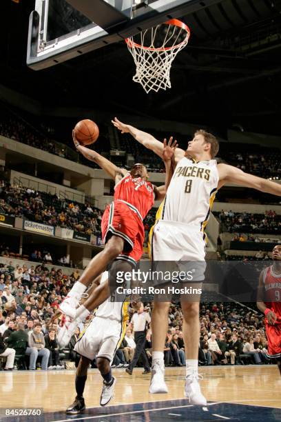Ramon Sessions of the Milwaukee Bucks goes up for a shot against Rasho Nesterovic of the Indiana Pacers at Conseco Fieldhouse on January 28, 2009 in...