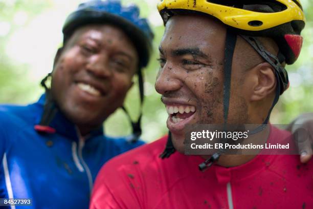 african bicyclists with mud on their faces - macchie di colore foto e immagini stock