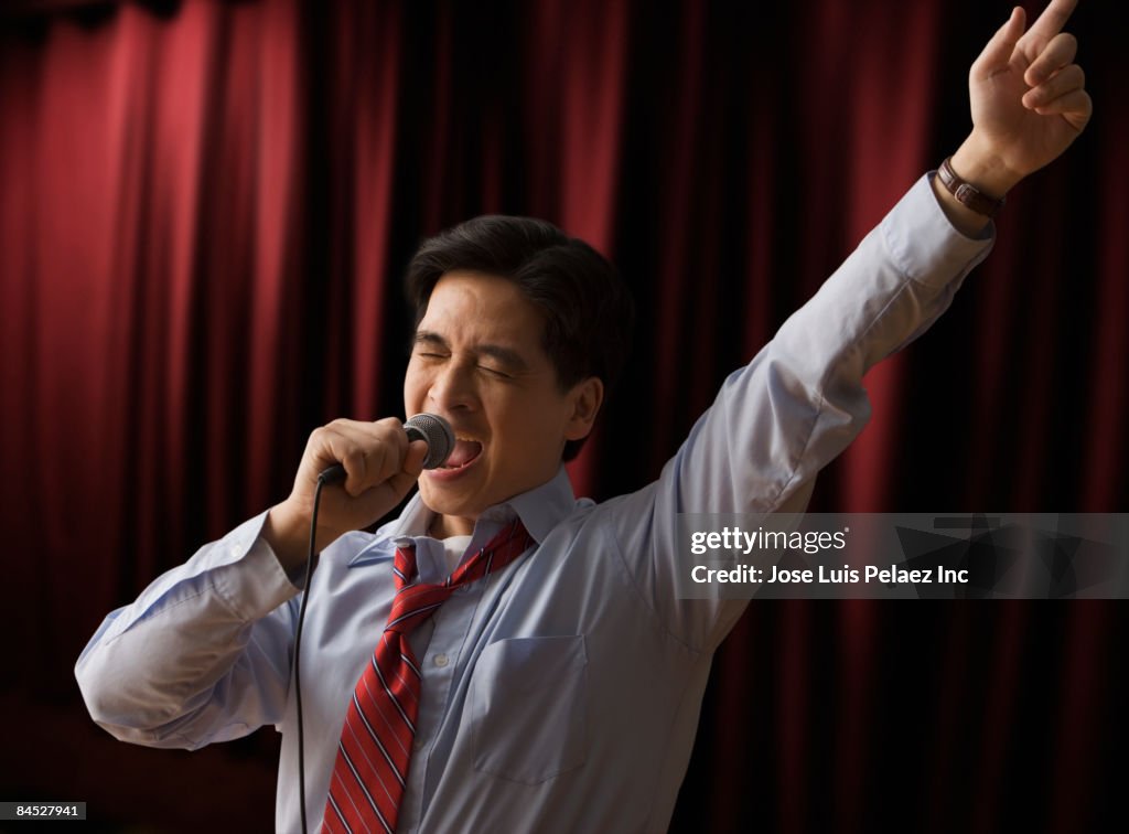 Chinese businessman singing karaoke