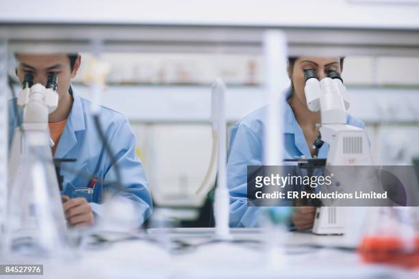 scientists working in laboratory with microscopes - japanese people lesson english stock pictures, royalty-free photos & images