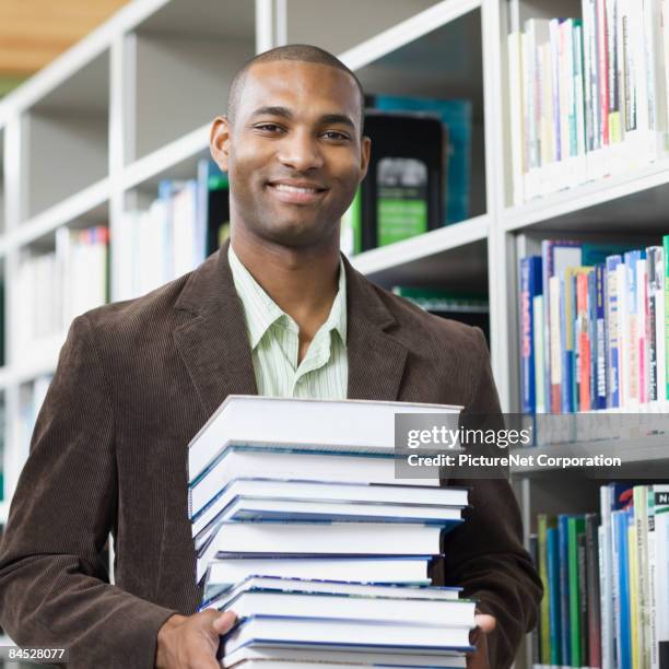 Man Stack Man Holding Stack Of Books Photos and Premium High Res Pictures - Getty ...