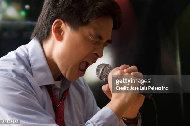 chinese businessman singing karaoke - microphone mouth stock pictures, royalty-free photos & images