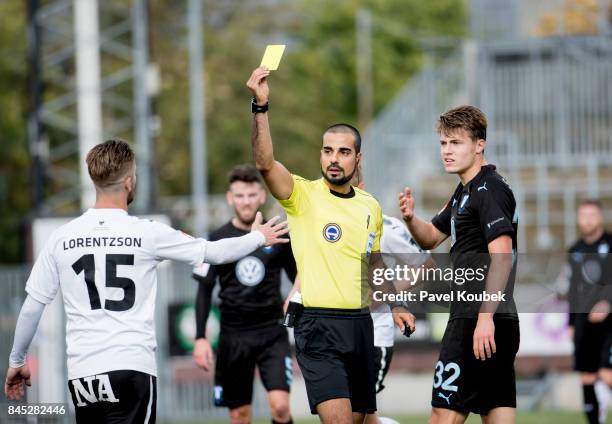 Ref. Mohammed Al-Hakim gives the yellow card to Martin Lorentzson of Orebro SK during the Allsvenskan match between Orebro SK and Malmo FF at Behrn...