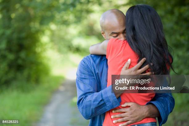 african couple hugging outdoors - sad boyfriend stock pictures, royalty-free photos & images