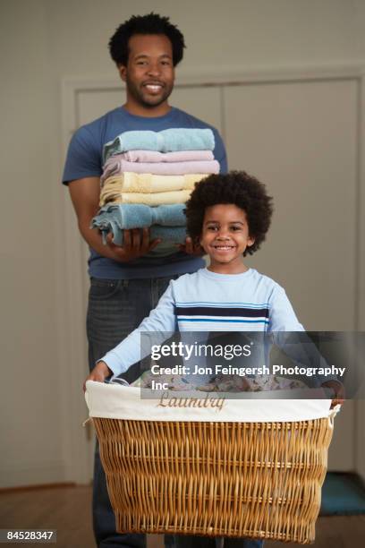 african father and son doing laundry - afro man washing stock pictures, royalty-free photos & images