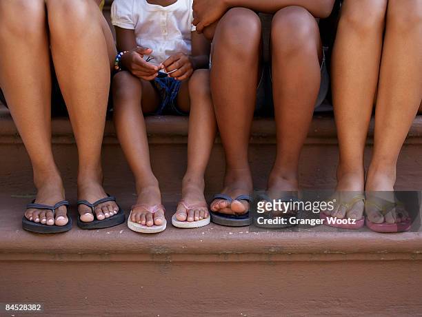 close up of family's feet in flip flops - tween heels stock pictures, royalty-free photos & images