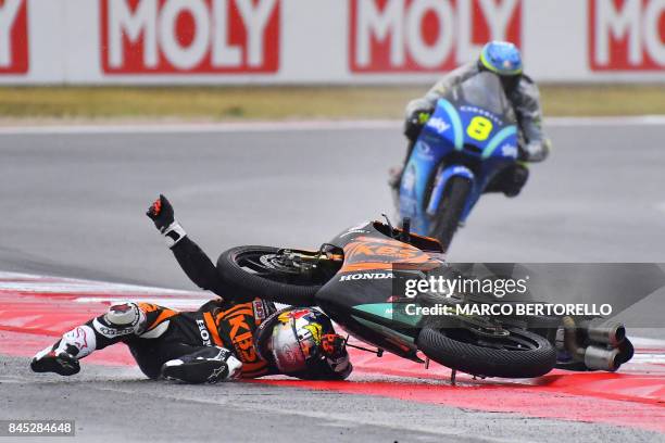 Sic Racing team's Japanese rider Ayumu Sasaki falls from his bike during the San Marino Moto3 Grand Prix race at the Marco Simoncelli Circuit in...