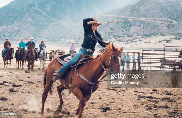 rodeo action cowgirl chasing bull with lasso in arena - lariat stock pictures, royalty-free photos & images