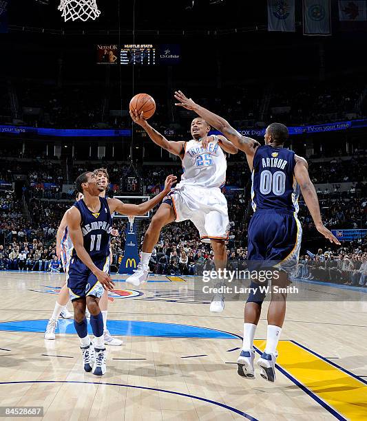 Earl Watson of the Oklahoma City Thunder goes to the basket against Mike Conley and Darrell Arthur of the Memphis Grizzlies at the Ford Center on...