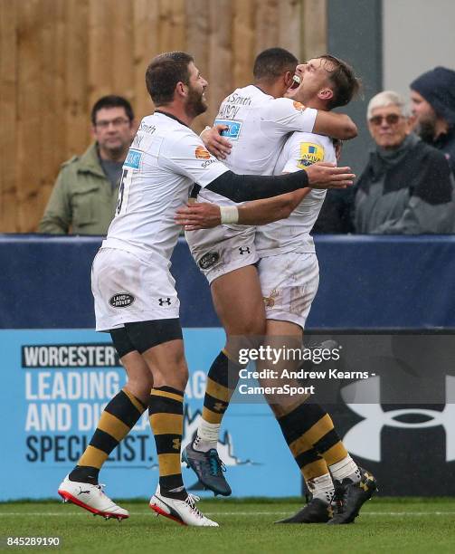 Wasps' Josh Bassett celebrates with his team mates after scoring a try during the Aviva Premiership match between Worcester Warriors and Wasps at...