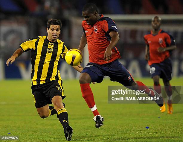 Uruguay's Peñarol Antonio Pacheco figths for the ball with Colombia's Medellin Juan Muriel during their Libertadores Cup football match on January...