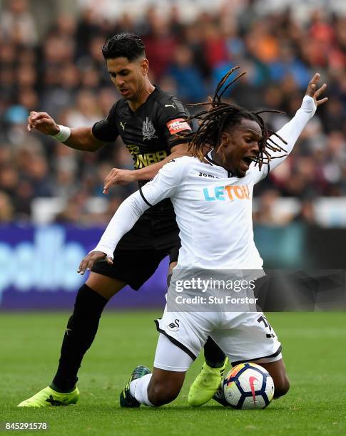 Ayoze Perez of Newcastle United tackles Renato Sanches of Swansea City during the Premier League match between Swansea City and Newcastle United at...