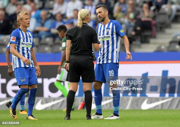 Per Skjelbred of Hertha BSC, Match referee Bibiana Steinhaus and Vedad Ibisevic of Hertha BSC during the game between Hertha BSC and Werder Bremen on...