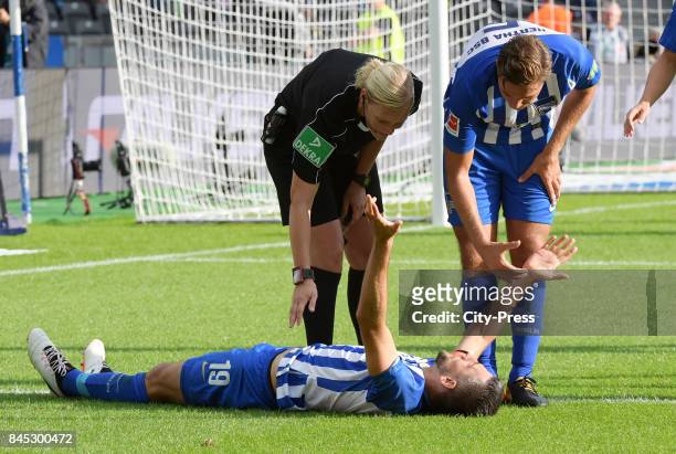 Vedad Ibisevic of Hertha BSC, Match referee Bibiana Steinhaus and Niklas Stark of Hertha BSC during the game between Hertha BSC and Werder Bremen on...