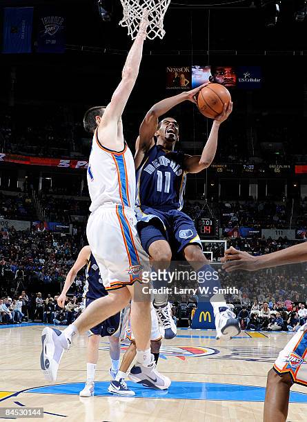 Mike Conley of the Memphis Grizzlies goes to the basket against Nick Collison of the Oklahoma City Thunder at the Ford Center on January 28, 2009 in...