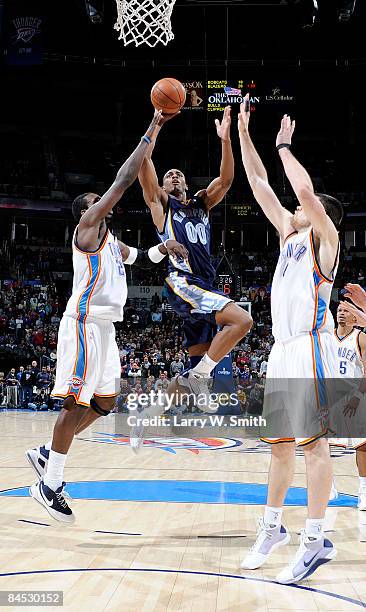 Darrell Arthur of the Memphis Grizzlies goes to the basket against Jeff Green and Nick Collison of the Oklahoma City Thunder at the Ford Center on...