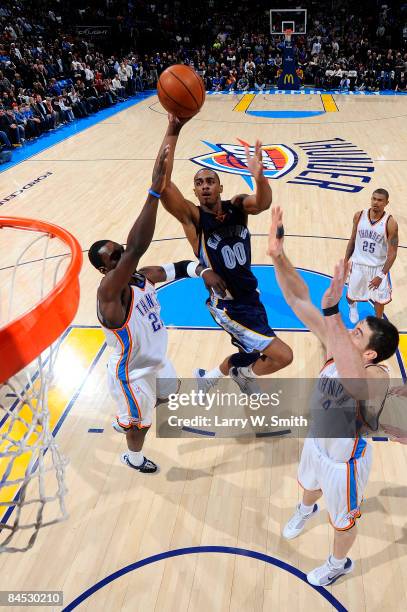 Darrell Arthur of the Memphis Grizzlies goes to the basket against Jeff Green and Nick Collison of the Oklahoma City Thunder at the Ford Center on...