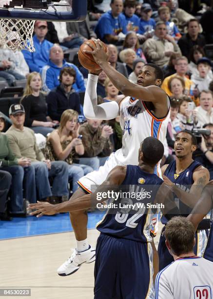 Desmond Mason of the Oklahoma City Thunder goes to the basket against O.J. Mayo of the Memphis Grizzlies at the Ford Center on January 28, 2009 in...