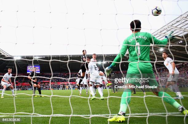 Jamaal Lascelles of Newcastle United scores his sides first goal during the Premier League match between Swansea City and Newcastle United at Liberty...
