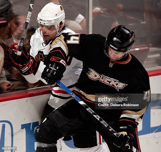 Patrick Sharp of the Chicago Blackhawks is elbowed by Chris Kunitz of the Anaheim Ducks during the game on January 28, 2009 at Honda Center in...