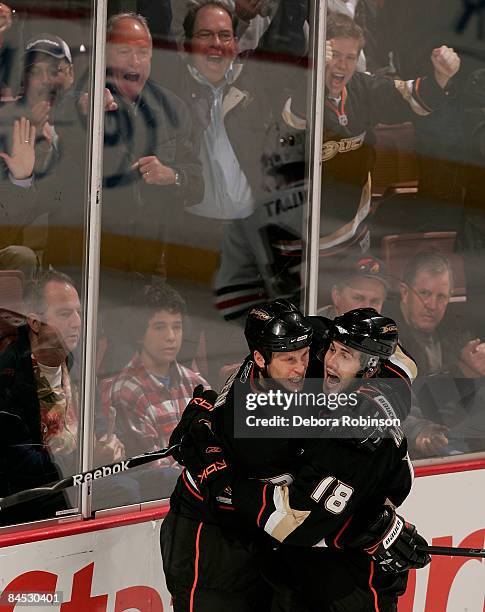 Drew Miller and Travis Moen of the Anaheim Ducks celebrate Moen's second period goal against the Chicago Blackhawks during the game on January 28,...