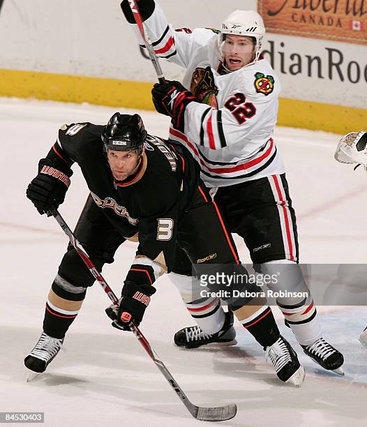 Troy Brouwer of the Chicago Blackhawks battles in the crease against Bret Hedican of the Anaheim Ducks during the game on January 28, 2009 at Honda...