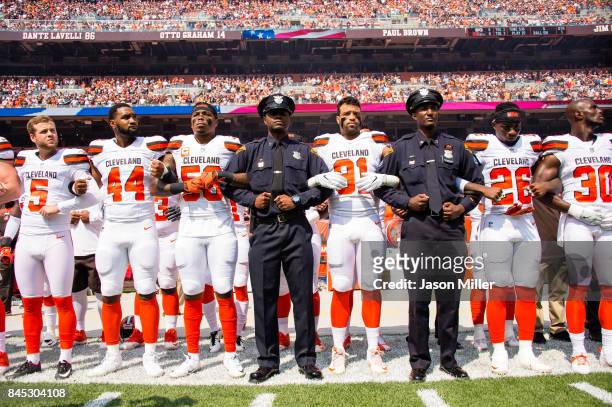 Members of the Cleveland Police join the Cleveland Browns on the sidelines during the National Anthem prior to the game against the Pittsburgh...